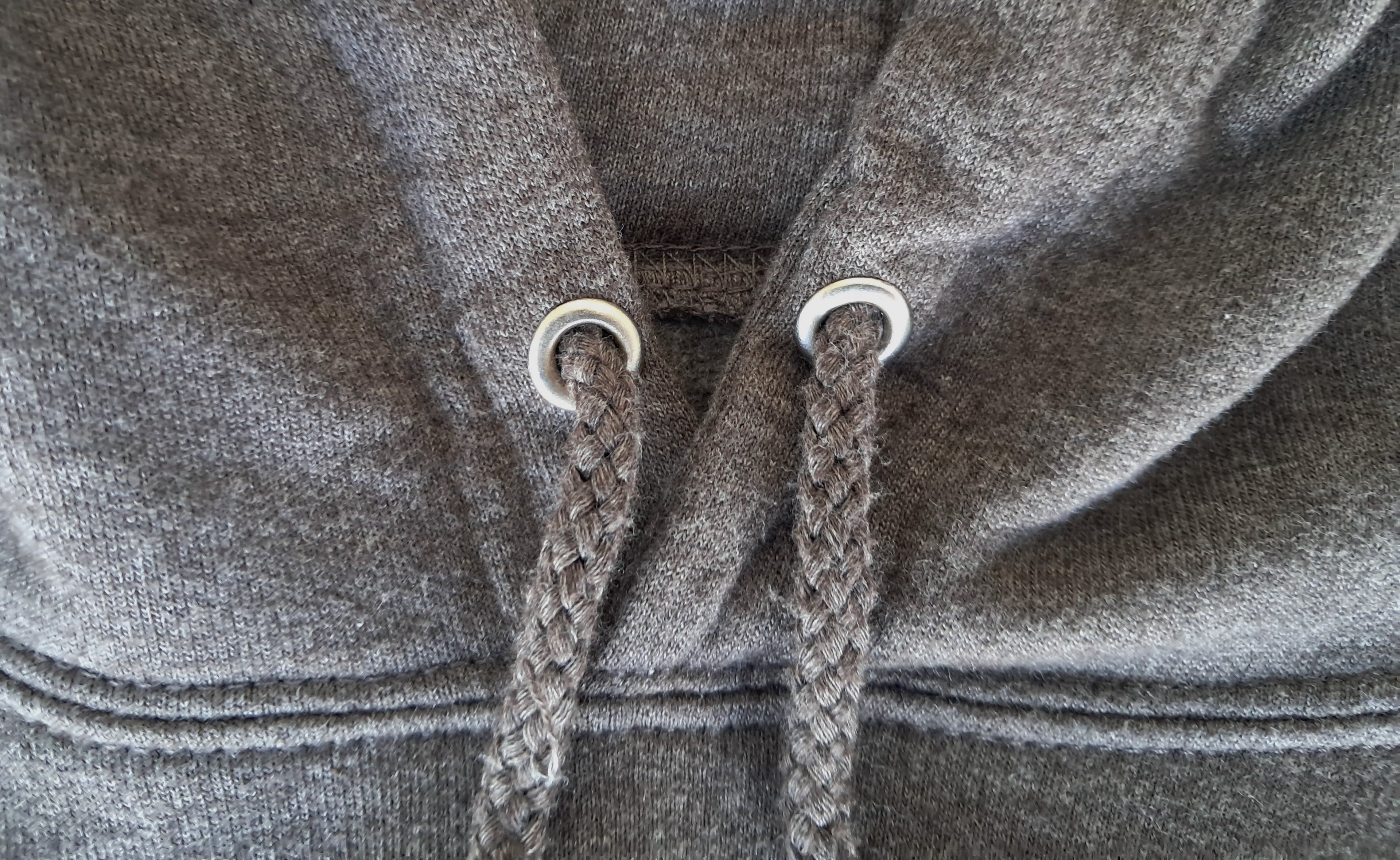 Close-up of gray hoodie strings and drawstrings promoting mental health and neurodivergence awareness by muted mayhem 