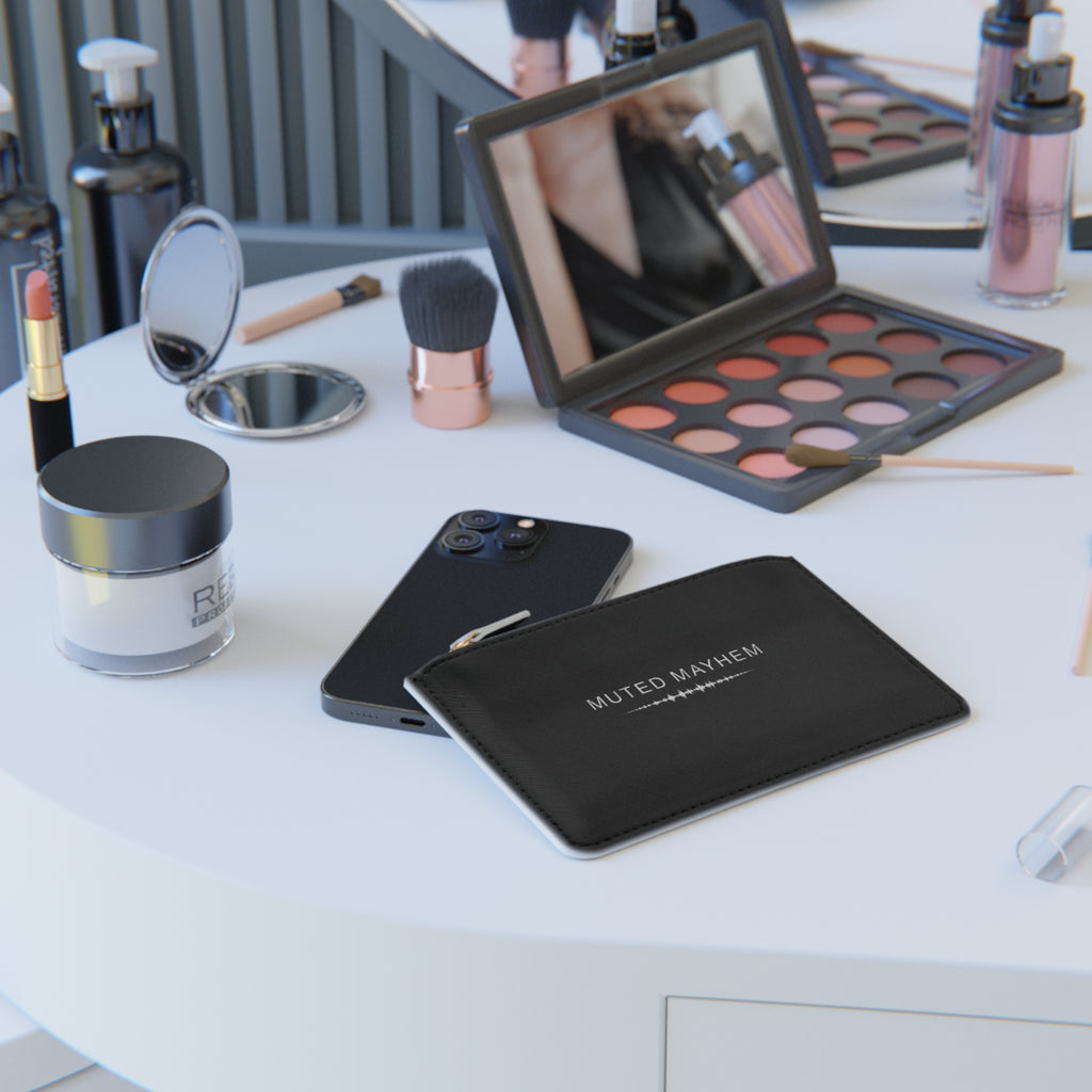 Makeup products including a phone, makeup palette, and brushes on a white surface.