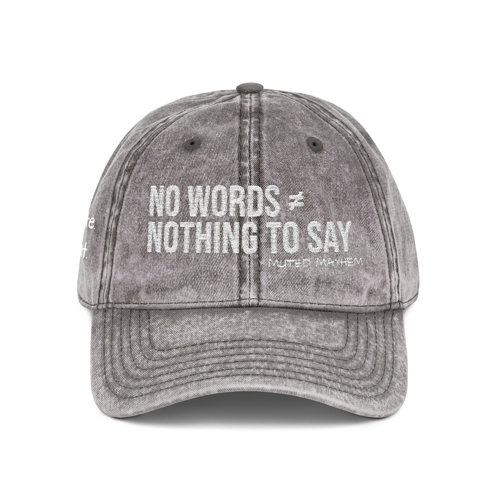 A gray acid-wash baseball cap with white embroidered text reading 'NO WORDS ★ NOTHING TO SAY' and smaller text 'MUTED MAYHEM' underneath, shown on a plain white background.