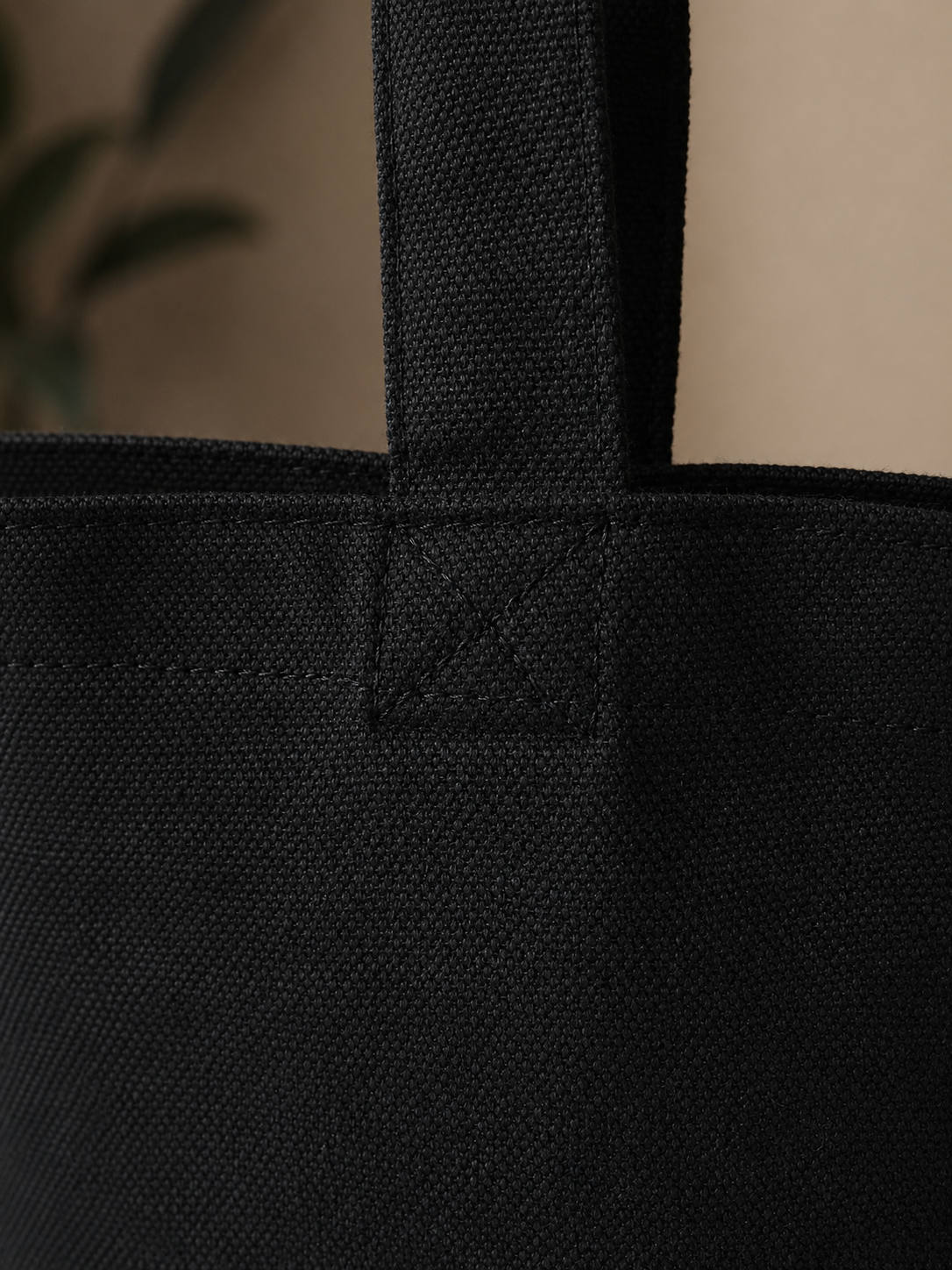 Black tote bag with a visible brand label on a neutral background promoting mental health and neurodivergence awareness by muted mayhem.