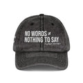 A dark gray acid-wash baseball cap with white embroidered text reading 'NO WORDS ★ NOTHING TO SAY' and 'MUTED MAYHEM' underneath, shown on a plain white background.
