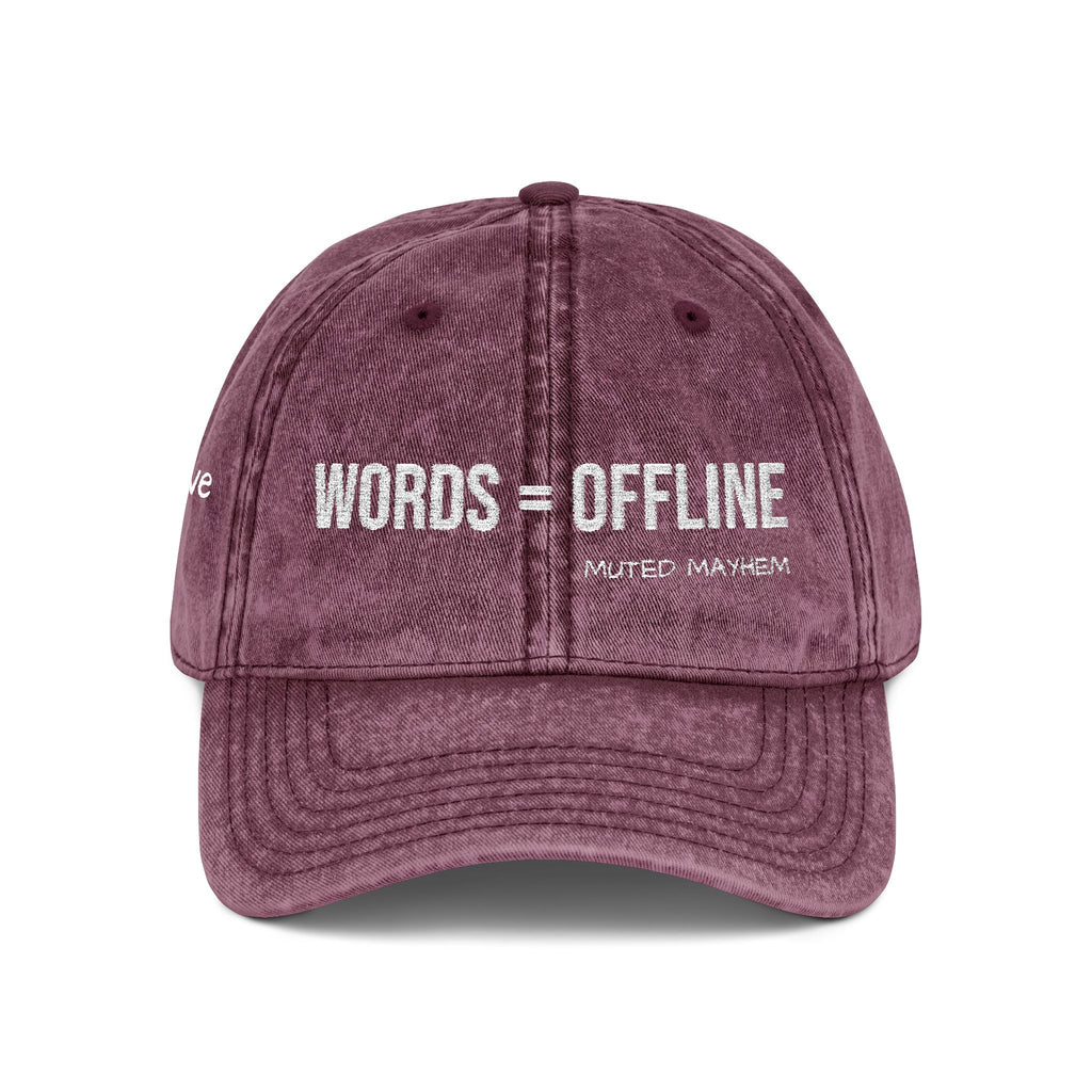 A washed mauve-purple baseball cap with 'words_offline' embroidered in white across the front, shown on a clean white background.